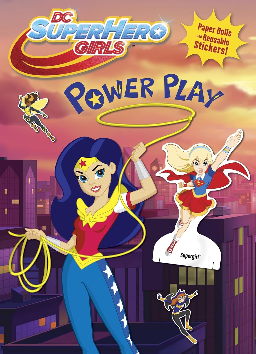 DC Super Hero Girls Power Play activity book cover featuring Wonder Woman, Supergirl, and other superhero characters on a city skyline background, with a yellow burst that says 'Paper Dolls & Reusable Stickers!'.