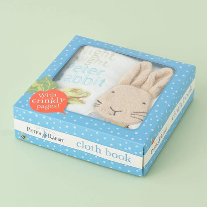 Peter Rabbit cloth book packaging with blue polka dot design on a light green background