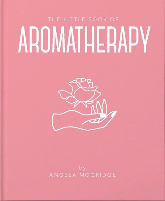 Pink book titled 'The Little Book of Aromatherapy' with a white rose and hand illustration on a pink background.
